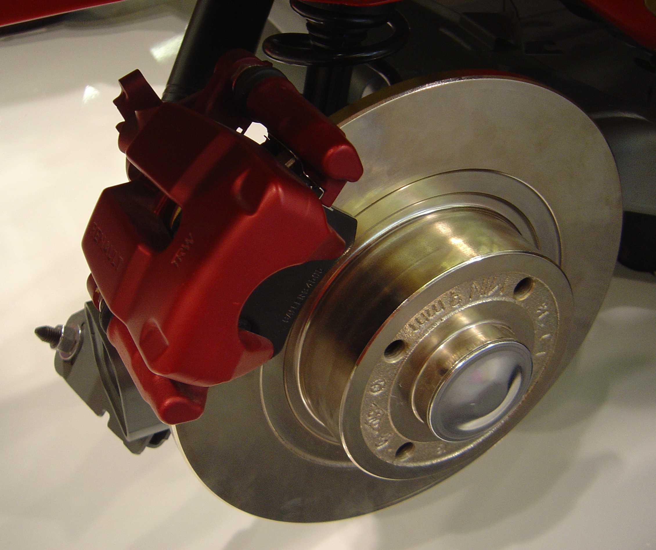How do tractor brakes differ from automotive brakes?