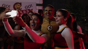 Kid Flash with cheerleaders.png