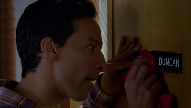 File:S06E01-Abed polishing Duncan nameplate.jpg