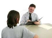 Guidance-counselor-taking-notes-people-image-79660121