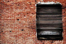 7742091-old-brick-wall-with-weathered-wood-boarded-window