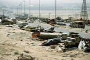 1024px-Demolished vehicles line Highway 80 on 18 Apr 1991