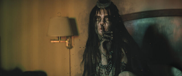 File:Enchantress holds her finger to her mouth.jpg