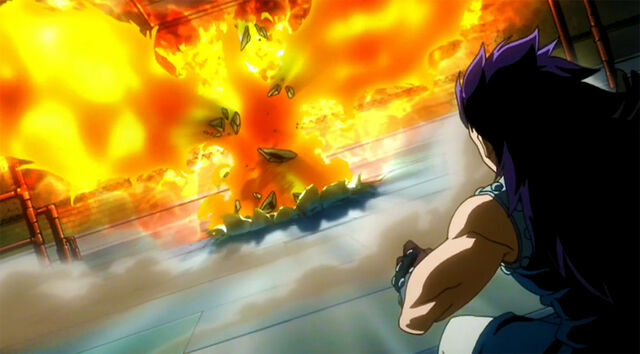 File:Natsu appears in front of Gajeel covered by his Flames.jpg