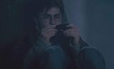 Harry Potter examining a shard of the Two-way Mirror given by Sirius Black.jpg