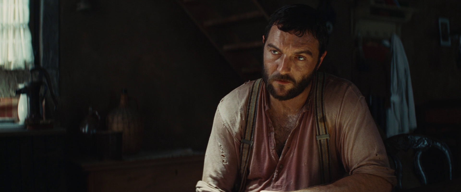 Image Perrier LaPadite looks at Hans Landa at the table.jpg