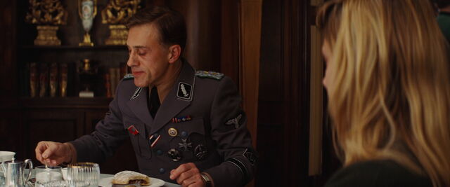 File:Hans landa adds some sugar in his espresso.jpg