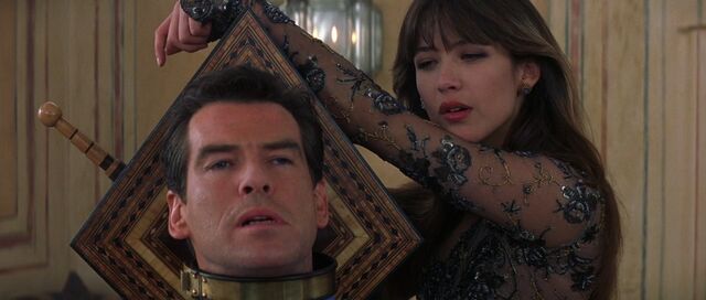 File:The World Is Not Enough - Elektra tortures Bond with an antique garotte.jpg