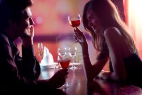 868281-young-couple-sharing-a-glass-of-red-wine-in-restaurant-celebrating-or-on-romantic-date-focus-on-woma