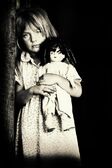 Ist2 8883747-portrait-of-little-girl-holding-doll-black-and-white