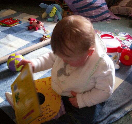 File:Baby exploring books.jpg