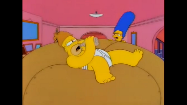 File:HomerIsLyingOnLardLadsColossalDonutAfterStealingItWhileDrinking.png
